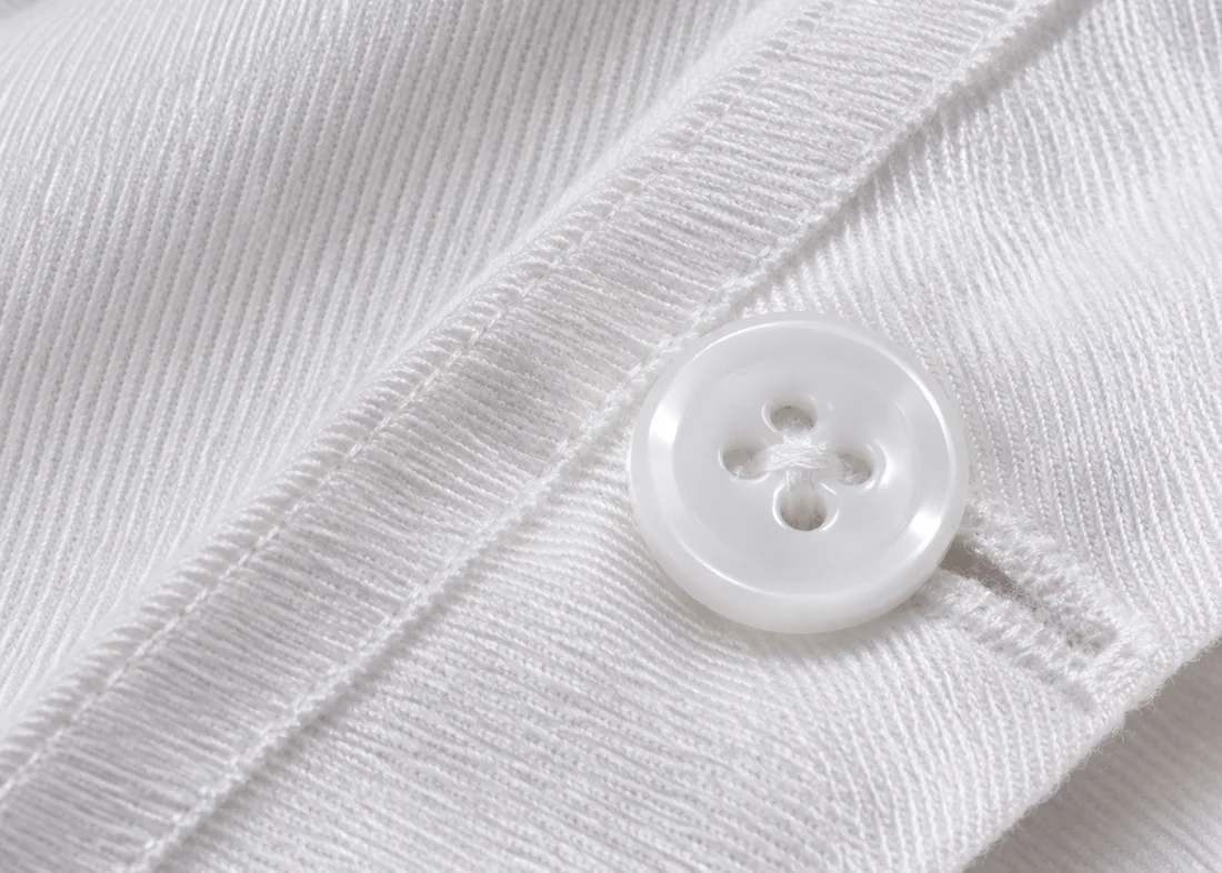 Detalle de la sarga y los botones cosidos de una chaquetilla